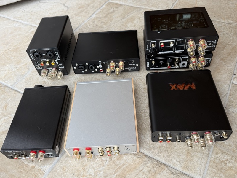 class D amplifier comparison rear panel view showing all six amplifiers from behind