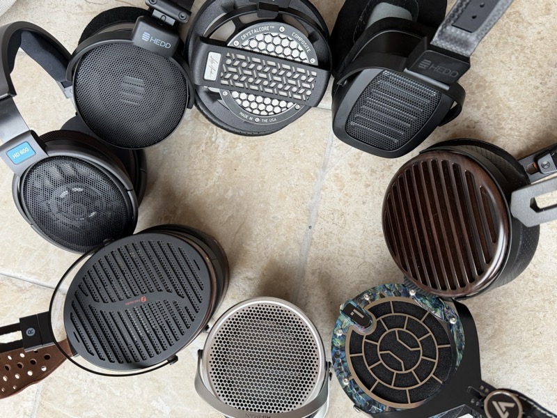 the Genesis One surrounded by comparison headphones from the collection