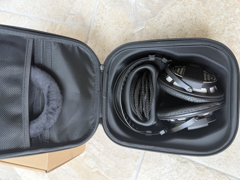 open case with headphone and cable
